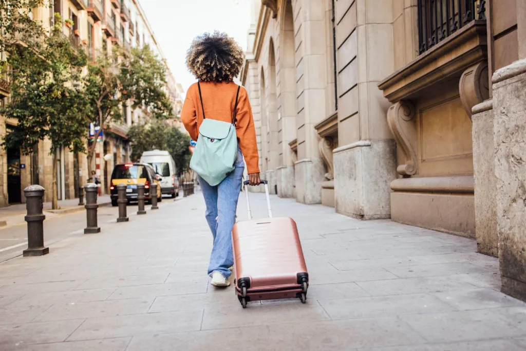 Rear view of African American woman on vacation arriving to Barcelona